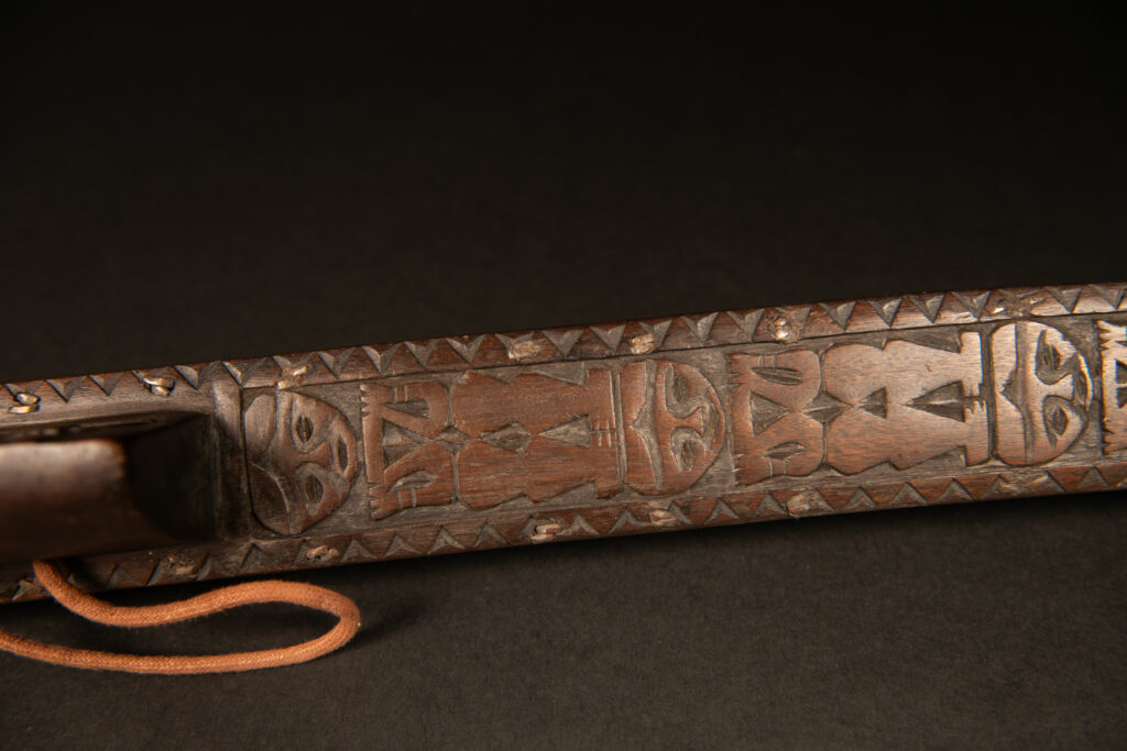Very beautiful ceremonial sword from the Paiwan tribe, carved with full-length human figures and faces on the side.