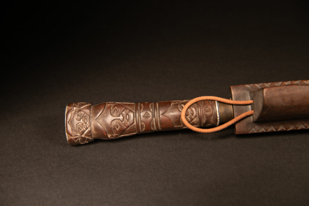 Very beautiful ceremonial sword from the Paiwan tribe, carved with full-length human figures and faces on the side.