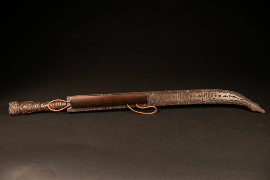 Very beautiful ceremonial sword from the Paiwan tribe, carved with full-length human figures and faces on the side.