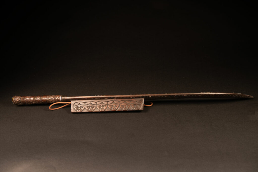Very beautiful ceremonial sword from the Paiwan tribe, carved with full-length human figures and faces on the side.