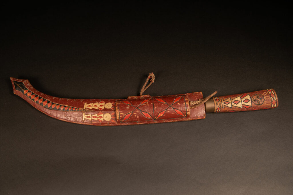 word from the Rukai tribe, painted in red, white, and black, engraved with serpent motifs and stylized human figures.