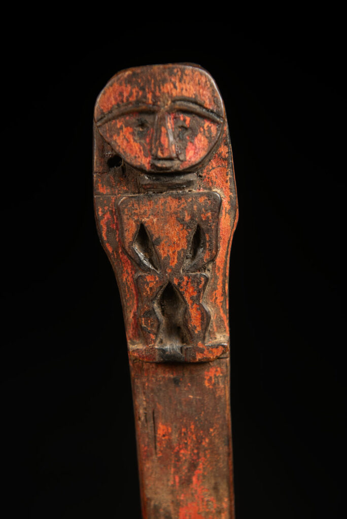 Beautiful 19th-century spoon, carved with a standing ancestor figure at the top and a magnificent double-headed serpent on the back. The spoon is stained red. Its size is 42 cm high.
