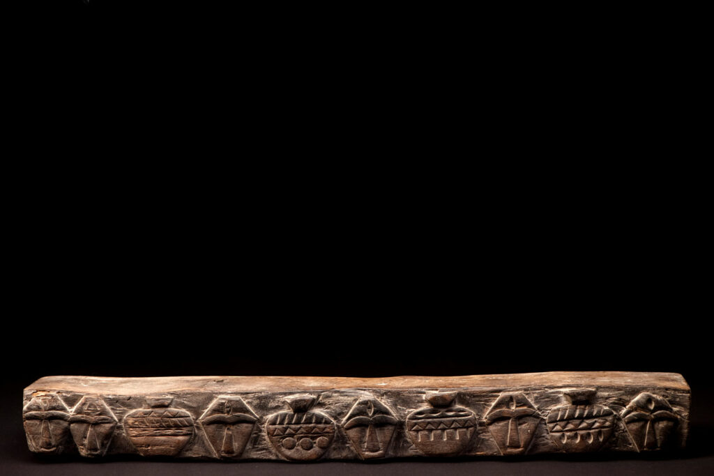 Headrest from Rukai tribe with face and pot patterns - South Taiwan