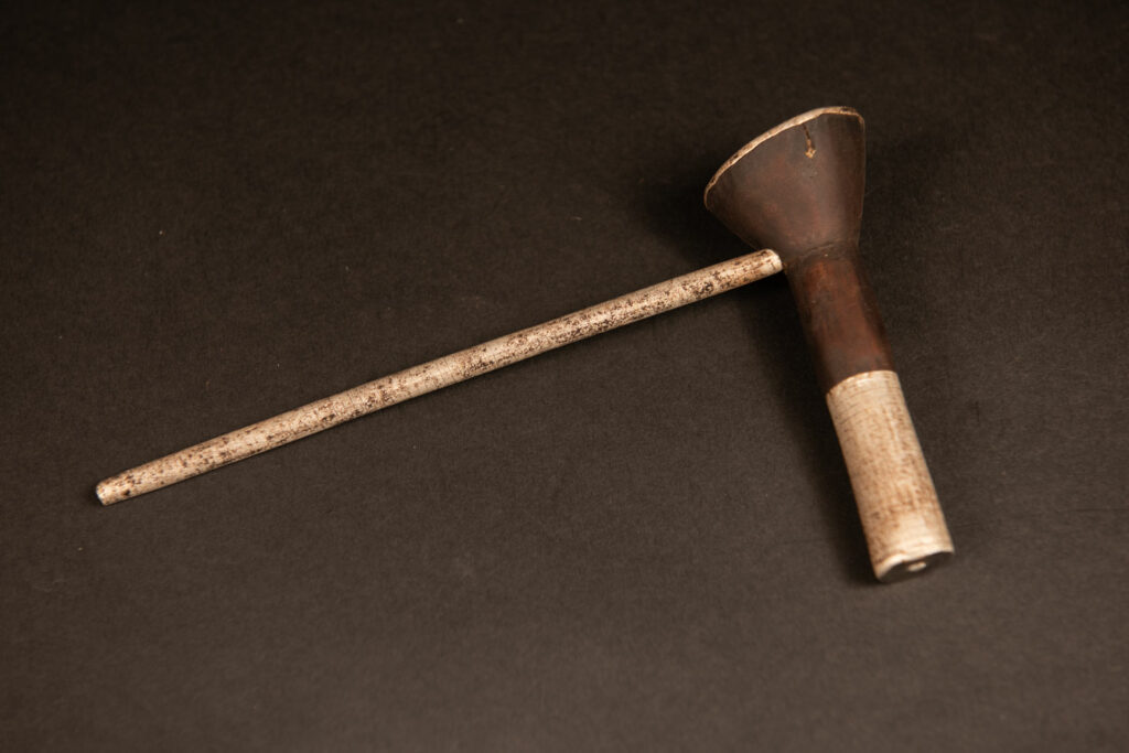 Pipe from Attayal tribe made of wood and aluminium . Part of wood are paint in silver.
