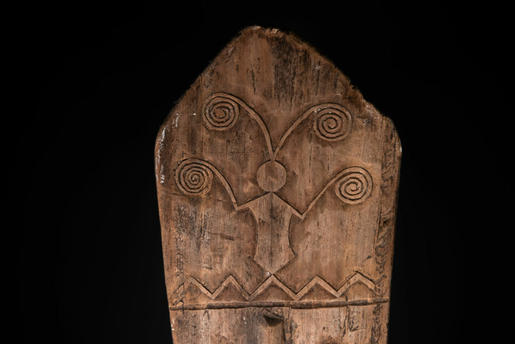 Ceremonial paddle from the Yami tribe (Orchid Island), carved with the deity Magamaog and two fish.