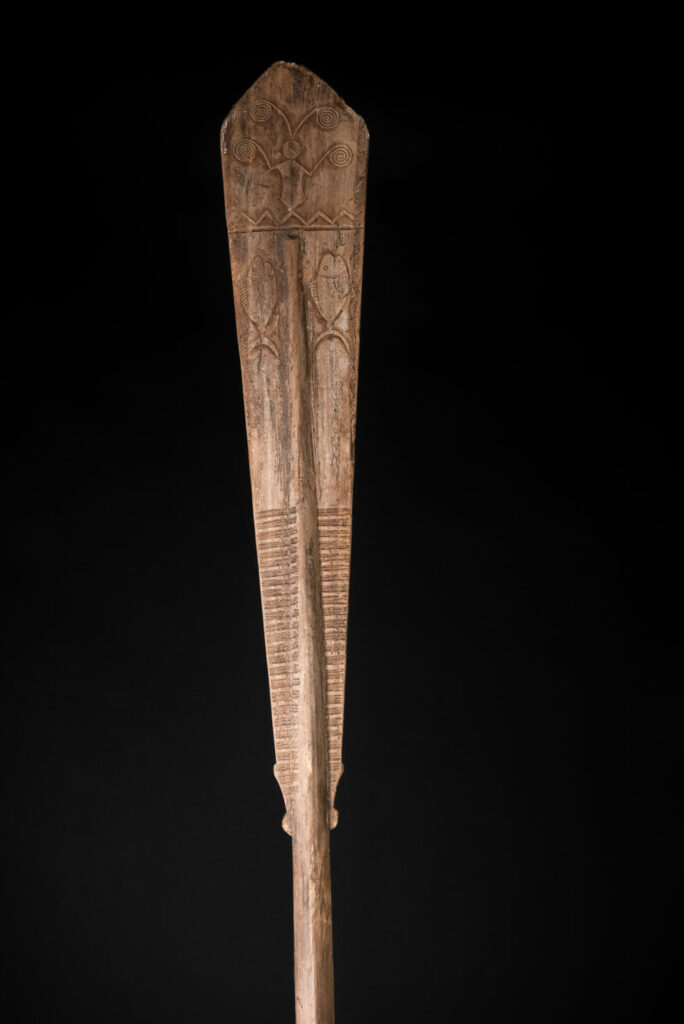 Ceremonial paddle from the Yami tribe (Orchid Island), carved with the deity Magamaog and two fish.