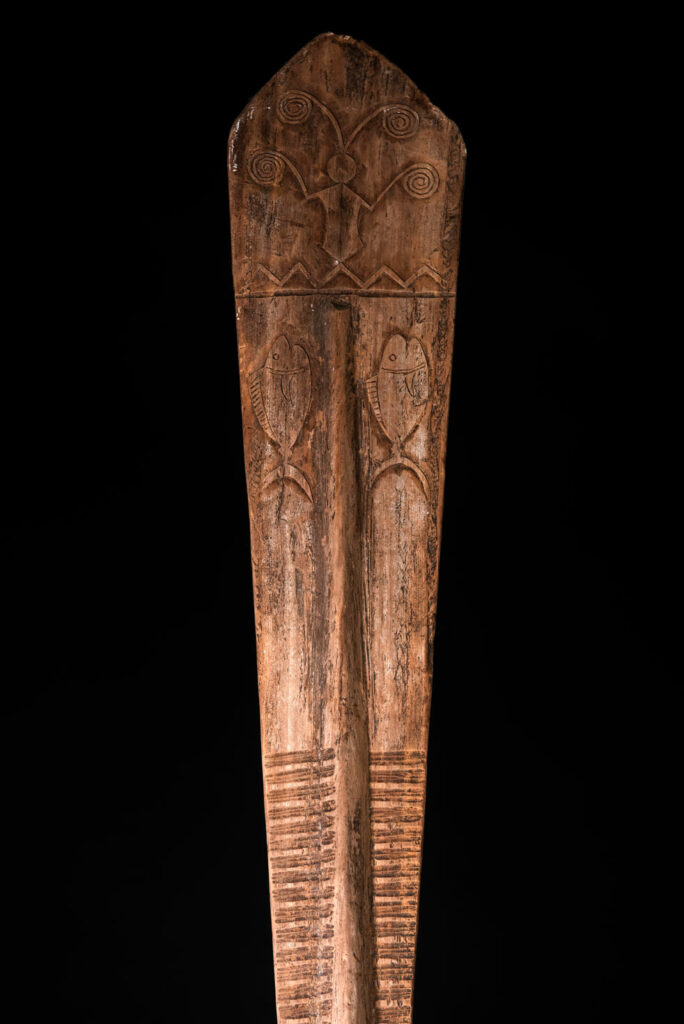 Ceremonial paddle from the Yami tribe (Orchid Island), carved with the deity Magamaog and two fish.