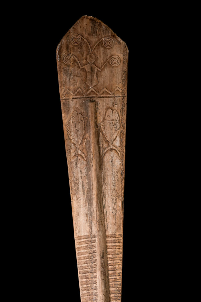 Ceremonial paddle from the Yami tribe (Orchid Island), carved with the deity Magamaog and two fish.