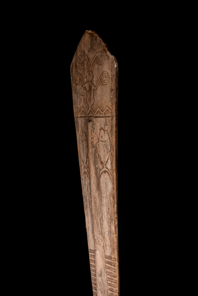 Ceremonial paddle from the Yami tribe (Orchid Island), carved with the deity Magamaog and two fish.