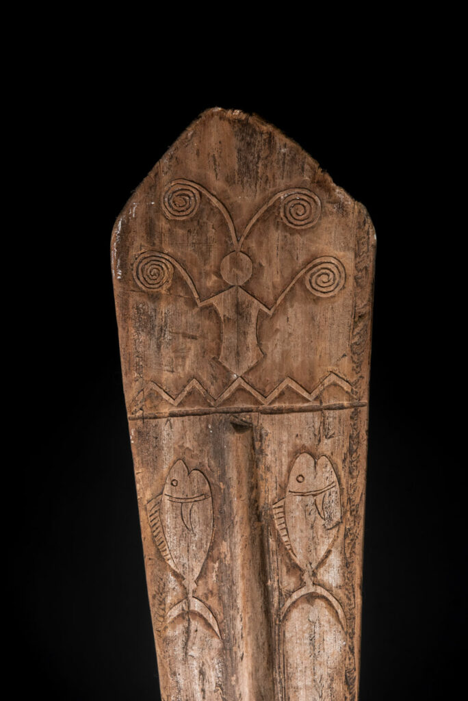 Ceremonial paddle from the Yami tribe (Orchid Island), carved with the deity Magamaog and two fish.