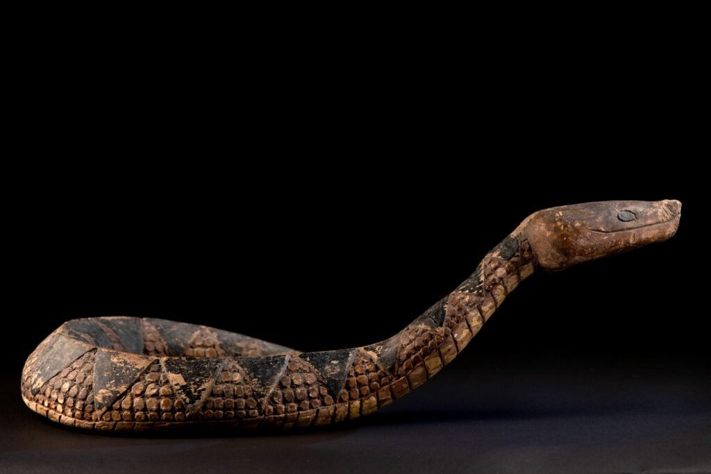 This painted snake sculpture frequently found in Paiwan houses holds a spiritual significance comparable to that of the crucifix for Christians.