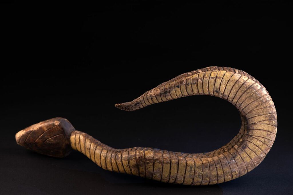 This painted snake sculpture frequently found in Paiwan houses holds a spiritual significance comparable to that of the crucifix for Christians.