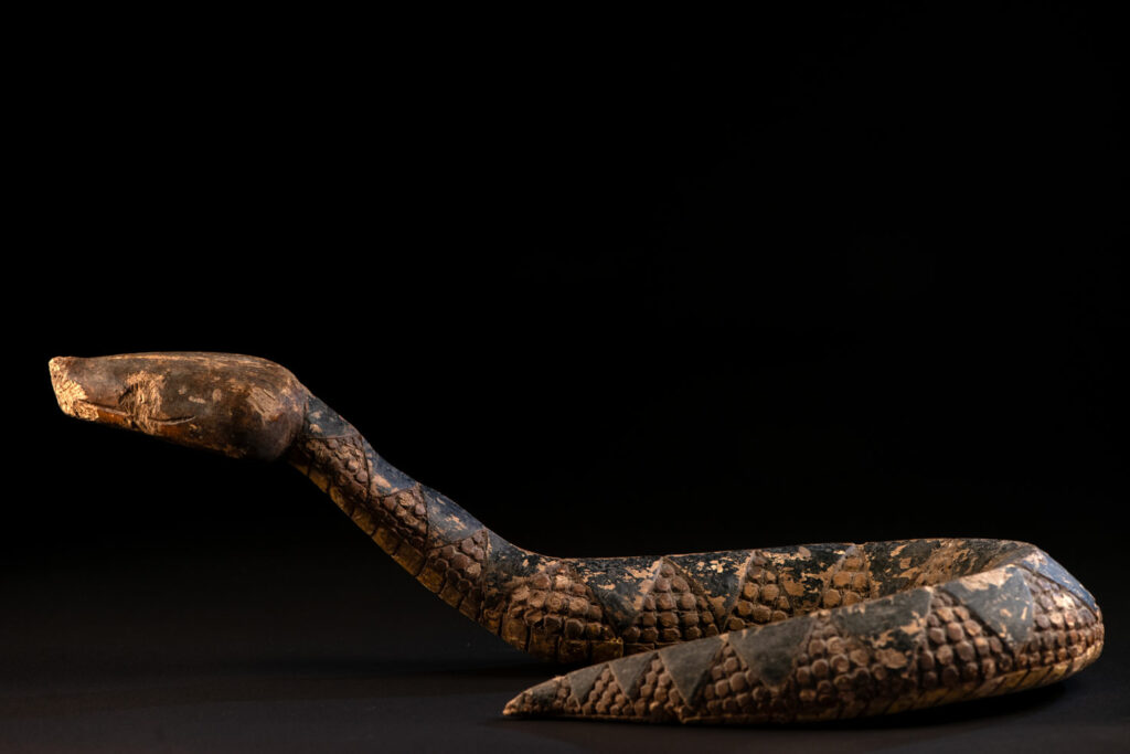 This painted snake sculpture frequently found in Paiwan houses holds a spiritual significance comparable to that of the crucifix for Christians.