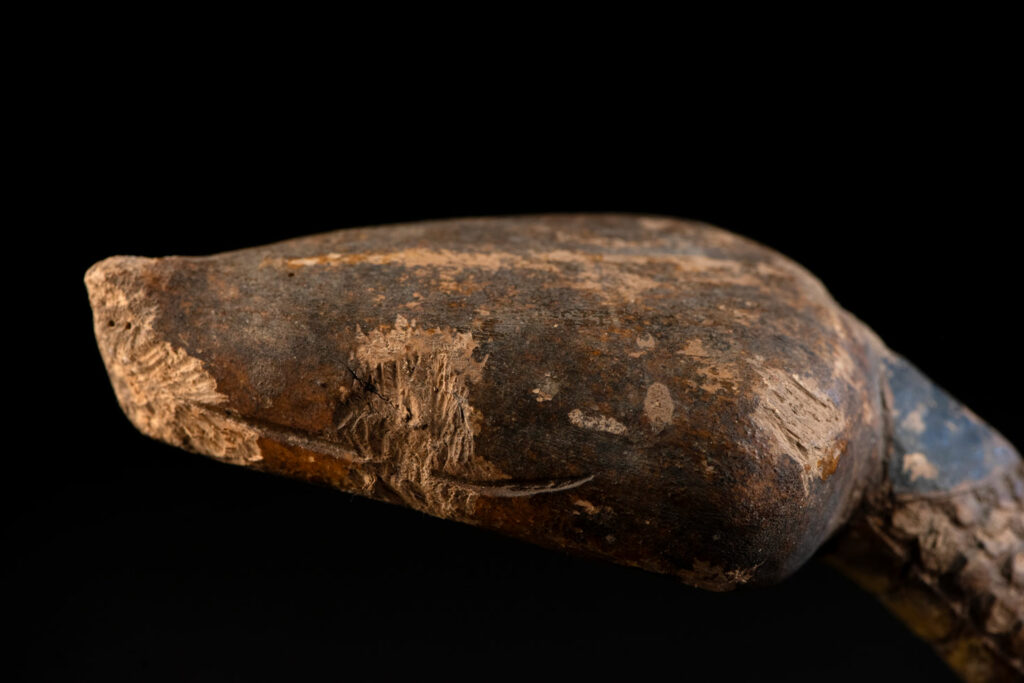 This painted snake sculpture frequently found in Paiwan houses holds a spiritual significance comparable to that of the crucifix for Christians.