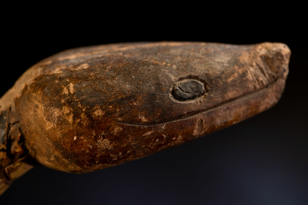 This painted snake sculpture frequently found in Paiwan houses holds a spiritual significance comparable to that of the crucifix for Christians.