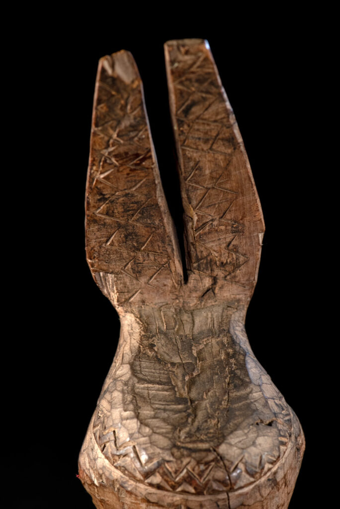 Paiwan tribe Statue depicting a male ancestor wearing a jacket and a ceremonial hat with huge eagle feather, sign of Valor and Vigor.