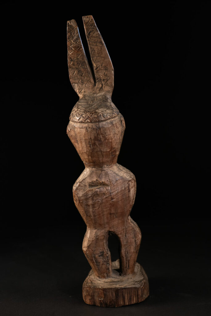 Paiwan tribe Statue depicting a male ancestor wearing a jacket and a ceremonial hat with huge eagle feather, sign of Valor and Vigor.