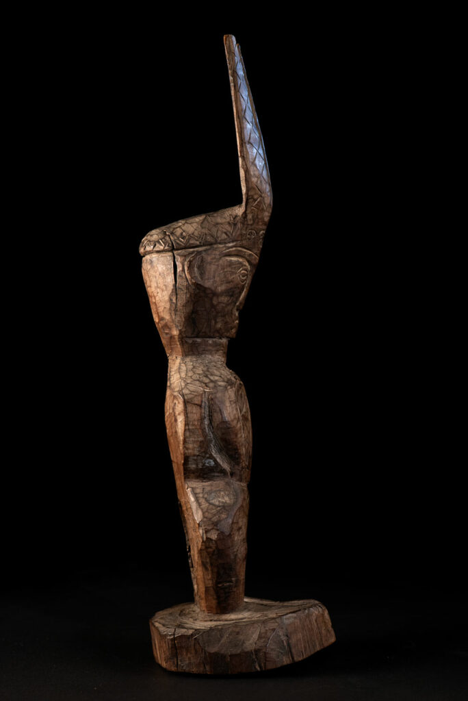 Paiwan tribe Statue depicting a male ancestor wearing a jacket and a ceremonial hat with huge eagle feather, sign of Valor and Vigor.