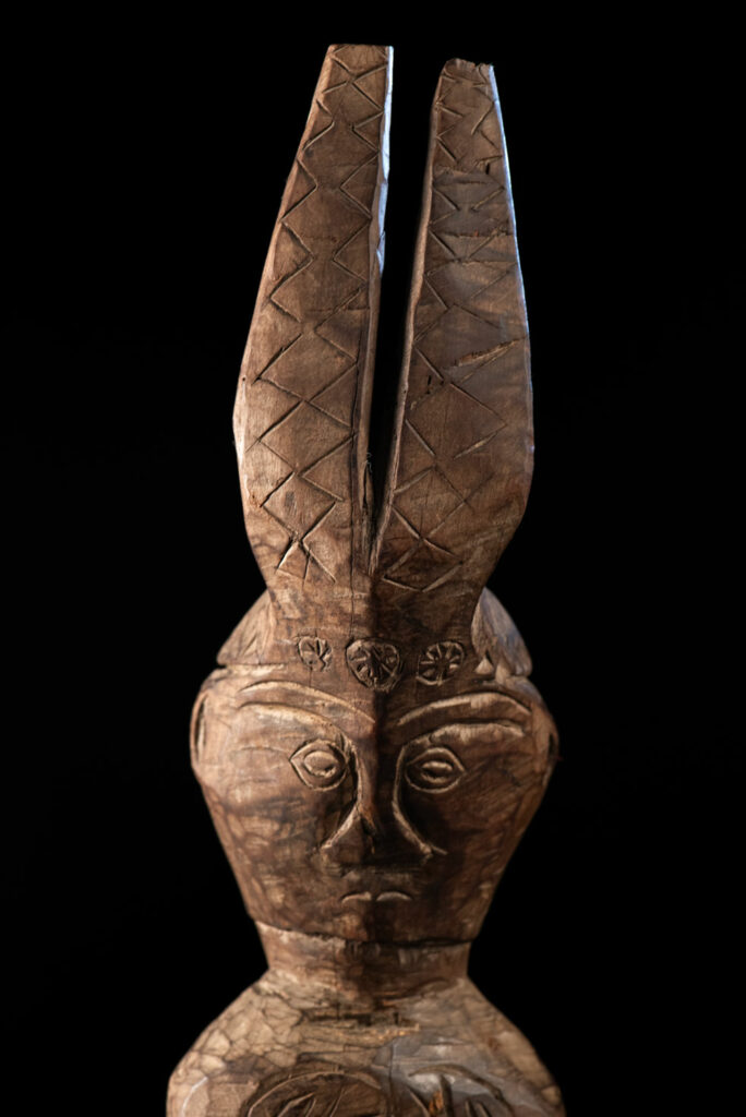 Paiwan tribe Statue depicting a male ancestor wearing a jacket and a ceremonial hat with huge eagle feather, sign of Valor and Vigor.