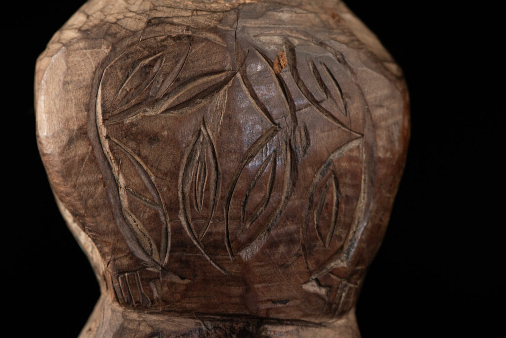 Paiwan tribe Statue depicting a male ancestor wearing a jacket and a ceremonial hat with huge eagle feather, sign of Valor and Vigor.