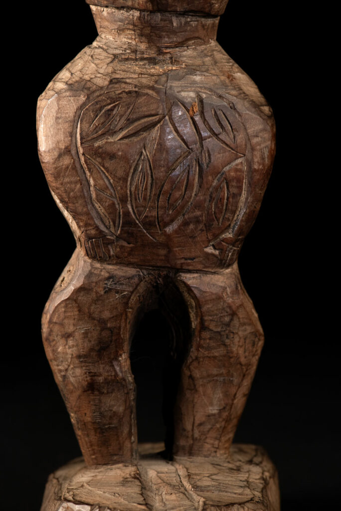 Paiwan tribe Statue depicting a male ancestor wearing a jacket and a ceremonial hat with huge eagle feather, sign of Valor and Vigor.