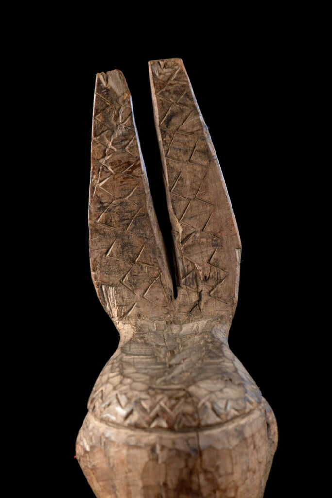 Paiwan tribe Statue depicting a male ancestor wearing a jacket and a ceremonial hat with huge eagle feather, sign of Valor and Vigor.