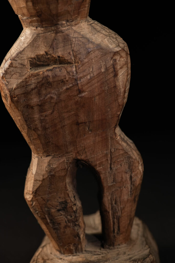 Paiwan tribe Statue depicting a male ancestor wearing a jacket and a ceremonial hat with huge eagle feather, sign of Valor and Vigor.