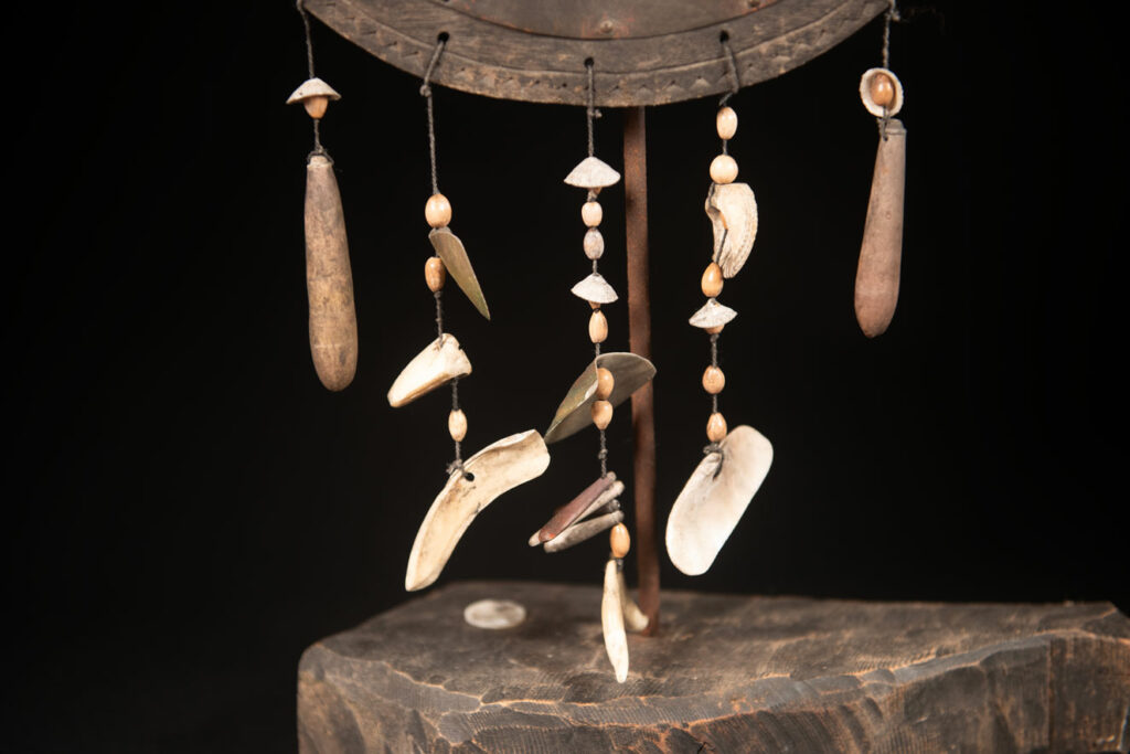 This half-moon-shaped chest ornament is made from wood chips of mangosteen, wuzhi (five-finger tree), or persimmon trees, and is traditionally worn by elderly men. Three arc-shaped copper pieces ( oxyded) of varying sizes are attached to the wooden base. The lower edge is adorned with various decorative elements considered beautiful.