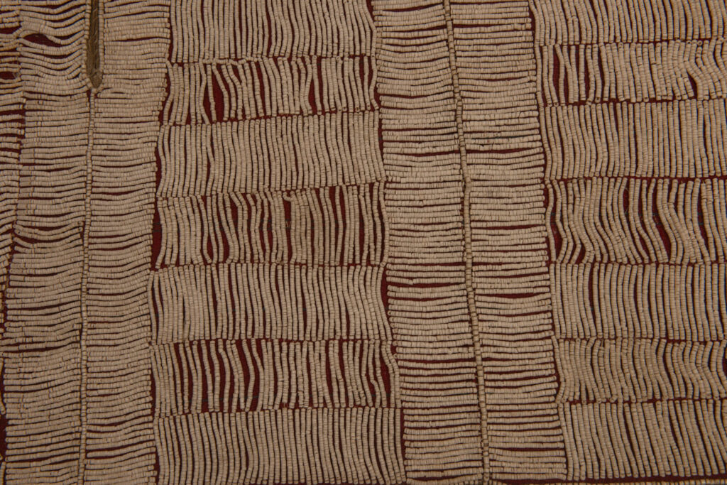 This beaded skirt from Attayal tribe is a piece of 89 cm long and 42 wide linen woven and embroidered with white shell beads. The white beads are made from giant clams. The Patterns are horizontal and vertical stripes . The upper part ( 14 cm ) is not beaded,