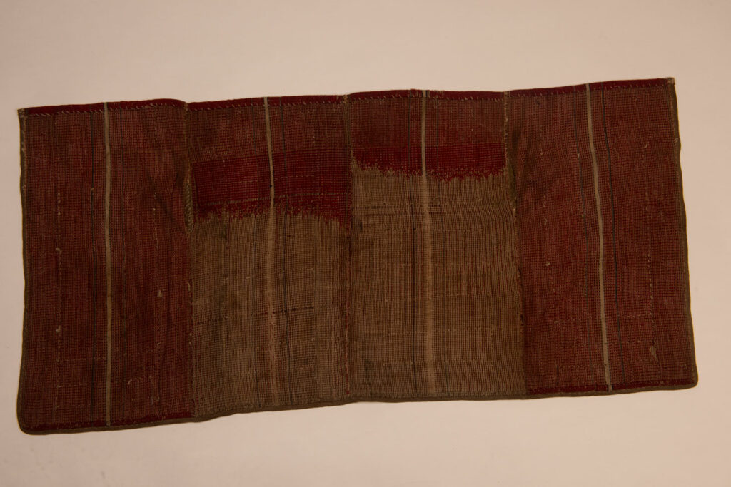 This beaded skirt from Attayal tribe is a piece of 89 cm long and 42 wide linen woven and embroidered with white shell beads. The white beads are made from giant clams. The Patterns are horizontal and vertical stripes . The upper part ( 14 cm ) is not beaded,