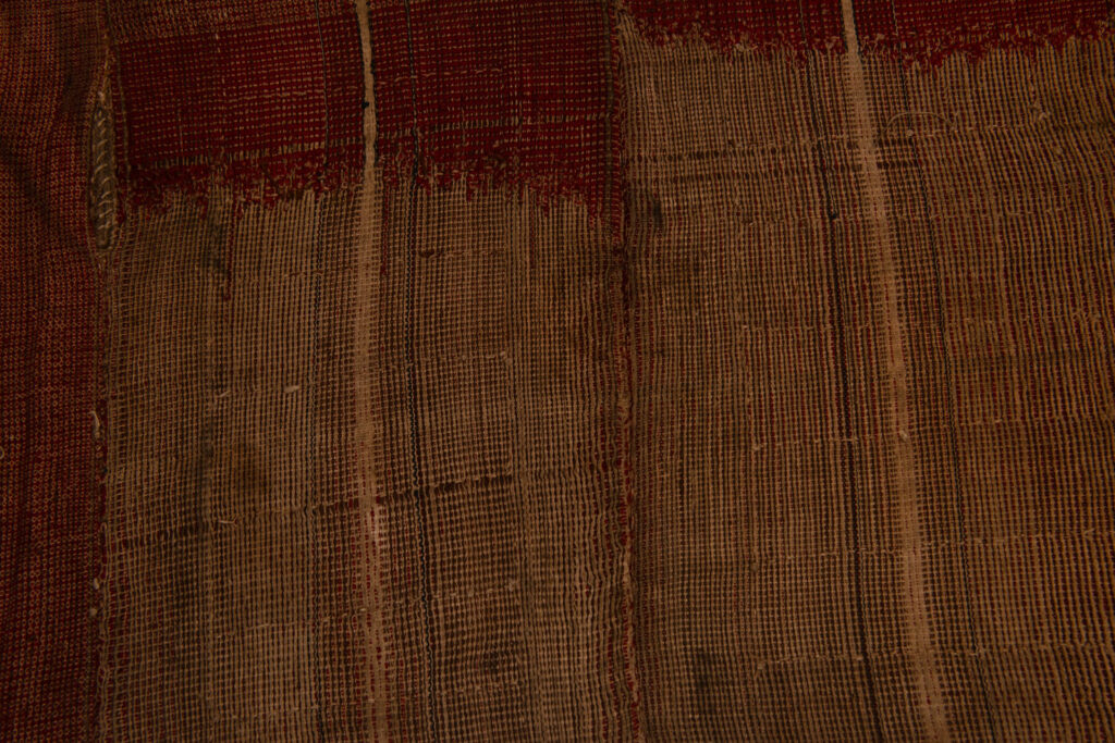 This beaded skirt from Attayal tribe is a piece of 89 cm long and 42 wide linen woven and embroidered with white shell beads. The white beads are made from giant clams. The Patterns are horizontal and vertical stripes . The upper part ( 14 cm ) is not beaded,