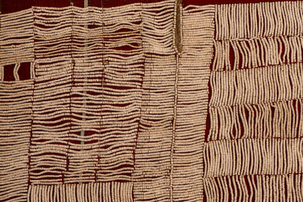 This beaded skirt from Attayal tribe is a piece of 89 cm long and 42 wide linen woven and embroidered with white shell beads. The white beads are made from giant clams. The Patterns are horizontal and vertical stripes . The upper part ( 14 cm ) is not beaded,