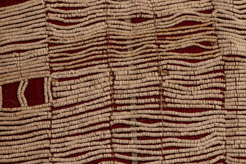 This beaded skirt from Attayal tribe is a piece of 89 cm long and 42 wide linen woven and embroidered with white shell beads. The white beads are made from giant clams. The Patterns are horizontal and vertical stripes . The upper part ( 14 cm ) is not beaded,