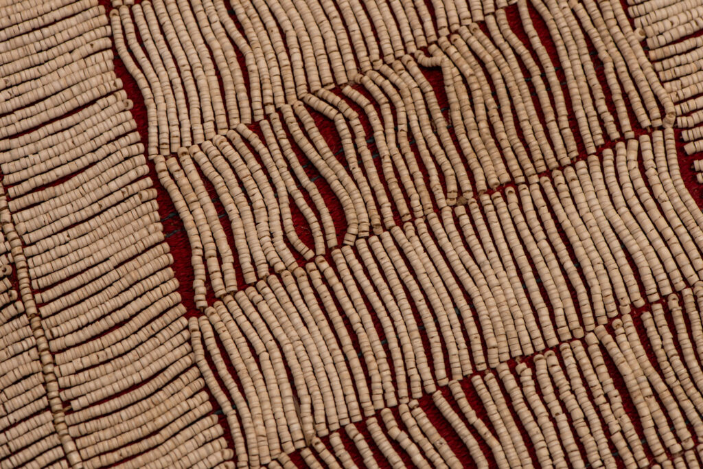 This beaded skirt from Attayal tribe is a piece of 89 cm long and 42 wide linen woven and embroidered with white shell beads. The white beads are made from giant clams. The Patterns are horizontal and vertical stripes . The upper part ( 14 cm ) is not beaded,