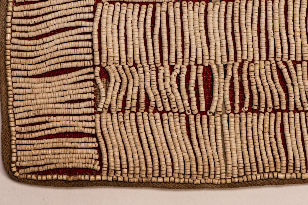 This beaded skirt from Attayal tribe is a piece of 89 cm long and 42 wide linen woven and embroidered with white shell beads. The white beads are made from giant clams. The Patterns are horizontal and vertical stripes . The upper part ( 14 cm ) is not beaded,