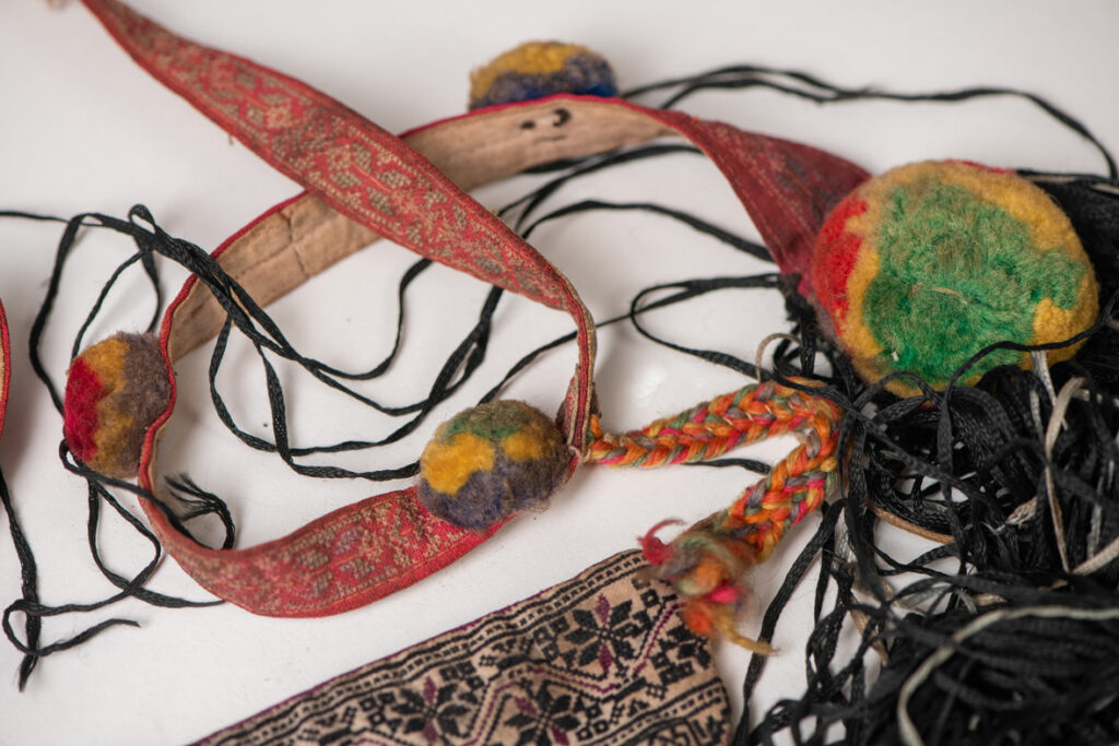 Ceremonial betel nut bag from the ami tribe, fully embroidered with distinctive motifs and inverted trapezoid shape.