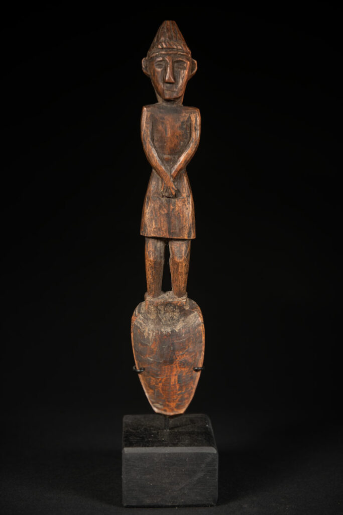 Large spoon from the Paiwan tribe, carved with a Paiwan man in traditional attire. Very finely carved.