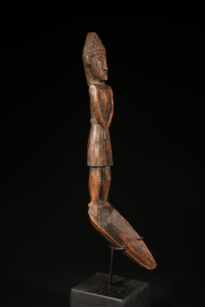 Large spoon from the Paiwan tribe, carved with a Paiwan man in traditional attire. Very finely carved.