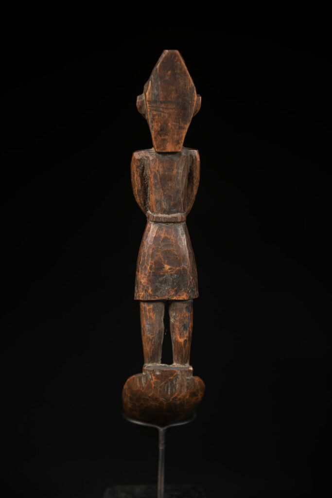 Large spoon from the Paiwan tribe, carved with a Paiwan man in traditional attire. Very finely carved.