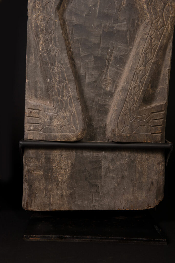 Pair of Paiwan Tribe Ancestor Panels, likely from Laiyi, carved with two figures—a male and a female. Their eyes, mouth, nipples, and navel are inlaid with porcelain. Their arms and legs are decorated with tribal motifs suggesting tattoos. Both figures wear hats, and the snakes carved above their heads indicate that they were important members of the nobility.