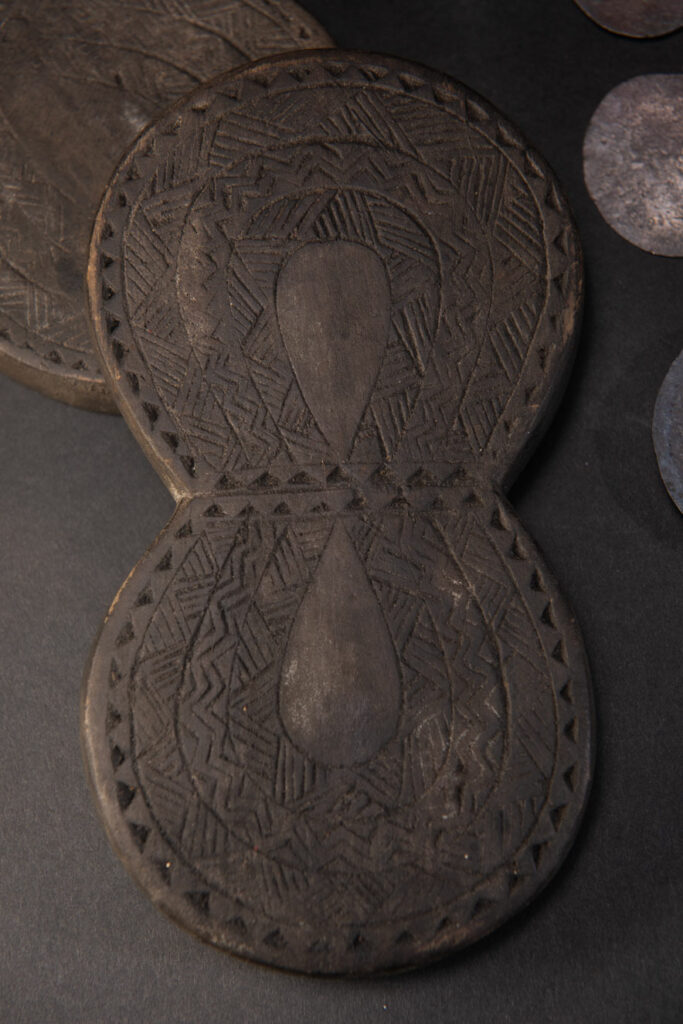Carved wooden box from the Yami tribe containing a men’s silver necklace called obai.