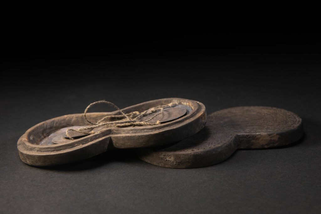Carved wooden box from the Yami tribe containing a men’s silver necklace called obai.