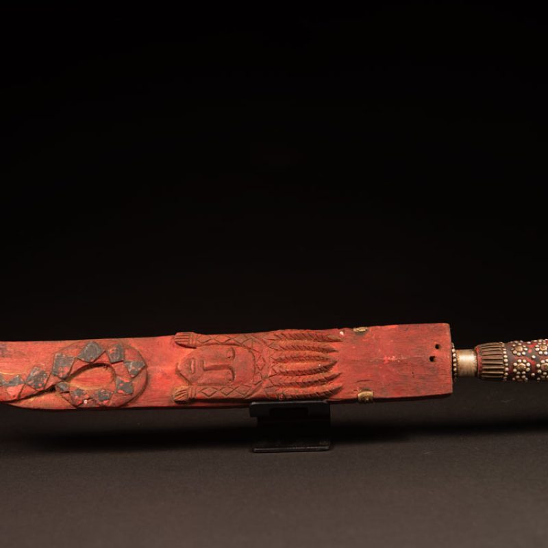 Typical Rukai-style sword with a wooden handle inlaid , steel wire and nail heads. ,The straight blade is long, and the scabbard is flat .