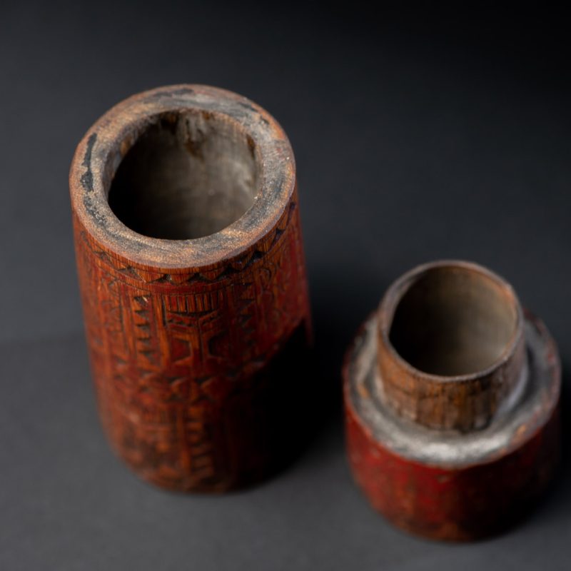 Shaman Bamboo case from the Paiwan tribe carved with geometrics patterns and tint with red pigments.