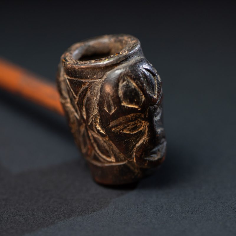Very ancient fine pipe made of precious wood from the Paiwan tribe, carved with human faces representing a Paiwan warriors on the front and the back.