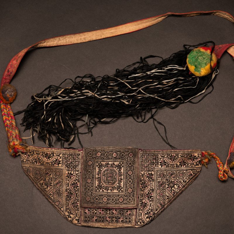 Ceremonial betel nut bag from the ami tribe, fully embroidered with distinctive motifs and inverted trapezoid shape.