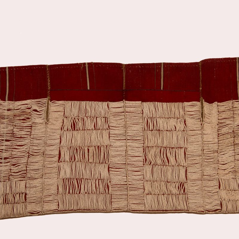This beaded skirt from Attayal tribe is a piece of 89 cm long and 42 wide linen woven and embroidered with white shell beads. The white beads are made from giant clams. The Patterns are horizontal and vertical stripes . The upper part ( 14 cm ) is not beaded,