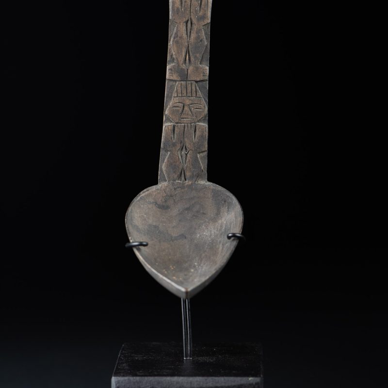 Ancient spoon from the Paiwan tribe, carved with two standing figures, one above the other.