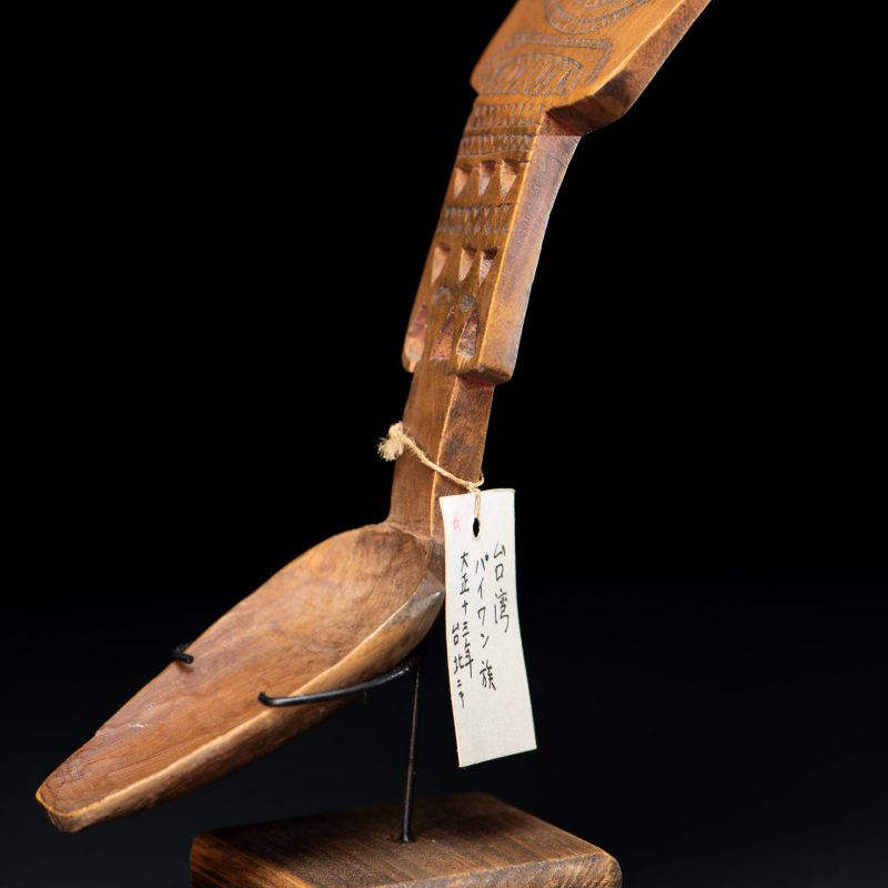Paiwan tribe ancient spoon and comb together done inside a yellow wood and carved with geometric pattern .