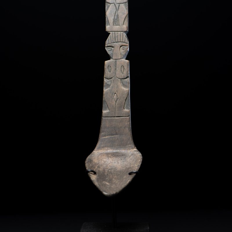 Ancient spoon from the Paiwan tribe, carved with two standing figures, one above the other.